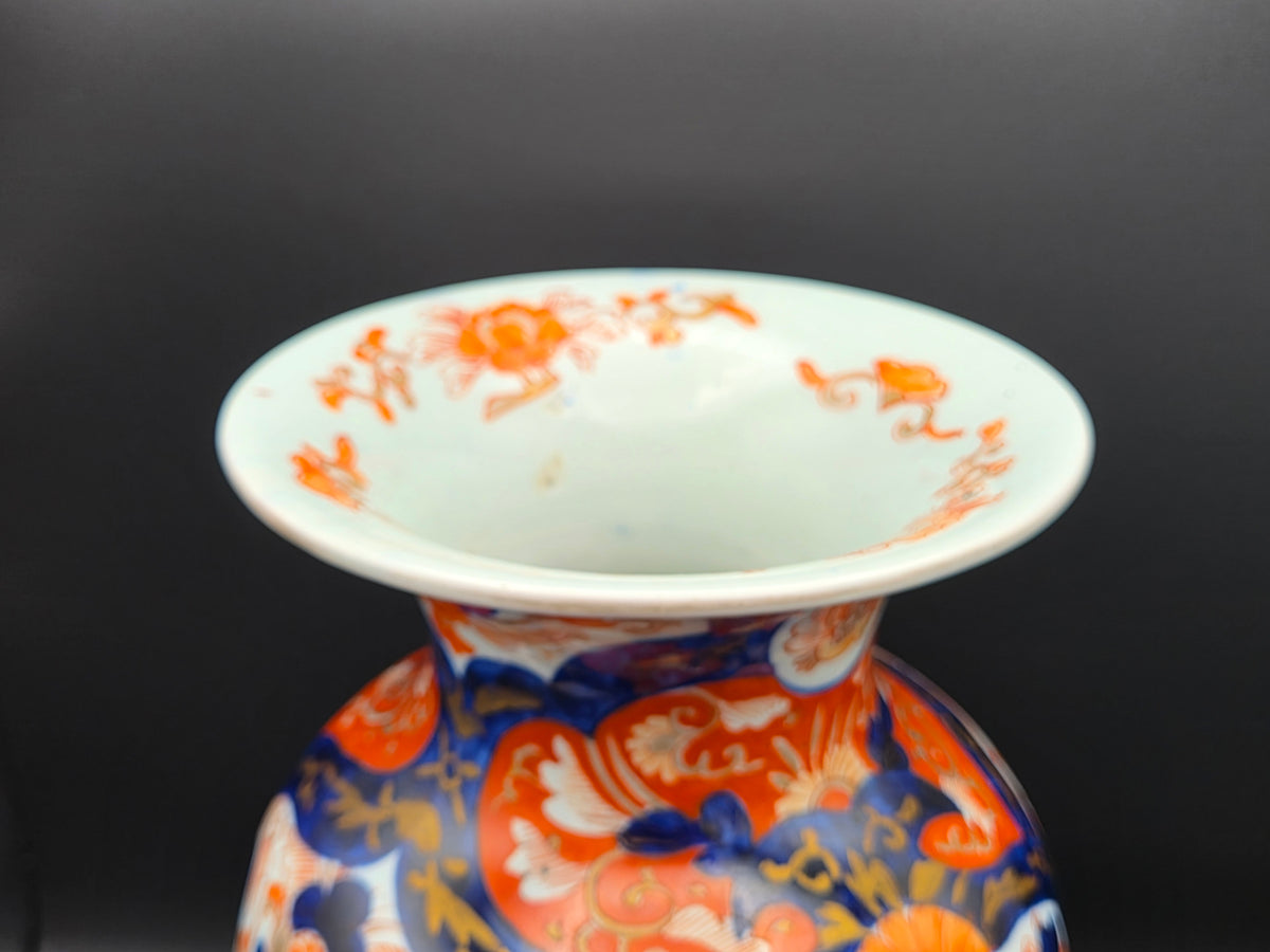 Porseleinen vaas: witte hals met ronde opening en blauw-oranje decor aan de rand.